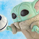 A mock-up of the Baby Yoda balloon, reaching for his toy, which will be featured in the 2021 Macy's Thanksgiving Day Parade.